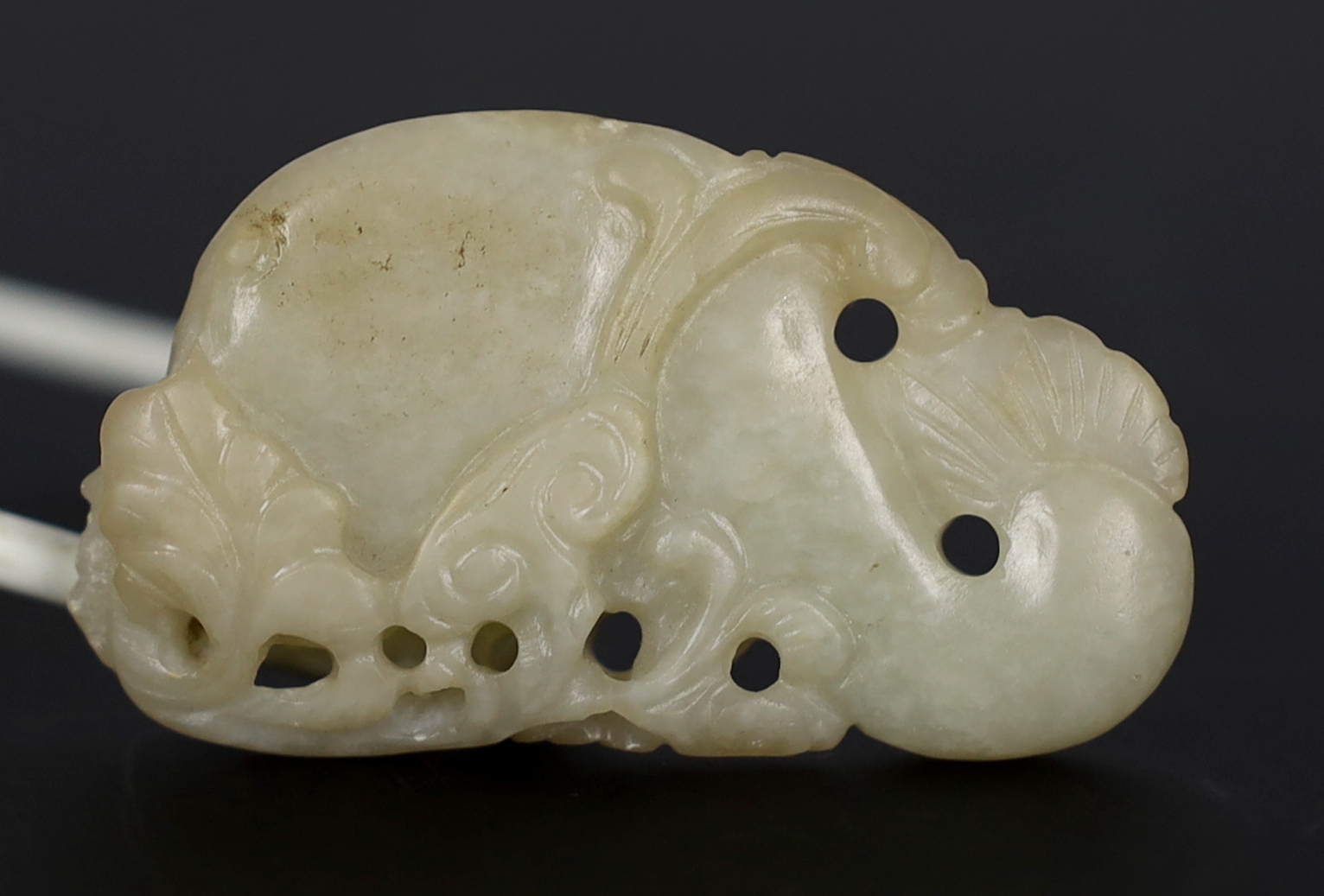 A Chinese pale celadon jade carving of a stylised catfish, probably 17th century